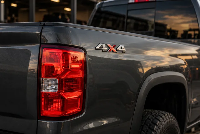 Rear quarter and taillight of a gray 4x4 pickup for work-truck repair